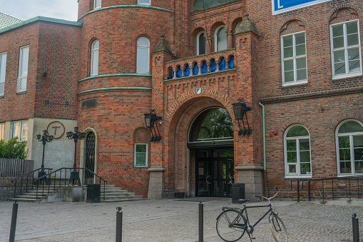 Old brick building with relief and german flag in Bremen. Above entrance is big relief.