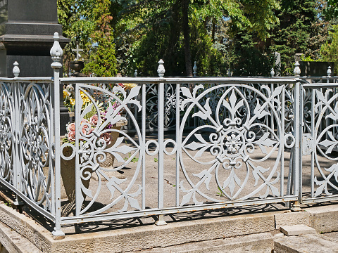 Old ornate metal fence in the public cemetery