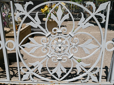 Old ornate metal fence in the public cemetery