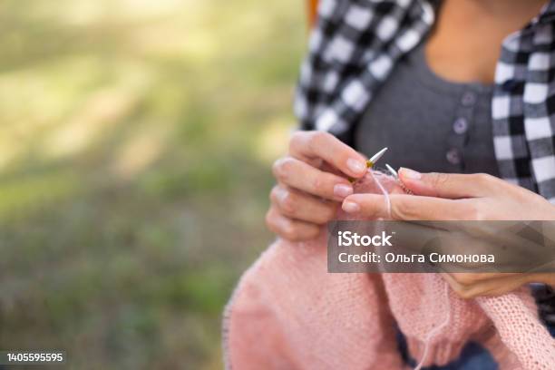 A Womans Hands Are Knitting A Woolen Cloth From A Ball Of Pink Threads Clothes With Their Own Hands Needlework Stock Photo - Download Image Now