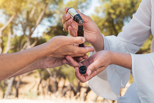 women testing aromatherpy oils on a summertime mindfulness ritual.
