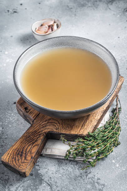 istock Bone meat chicken broth in a plate. Gray background. Top view 1405600455