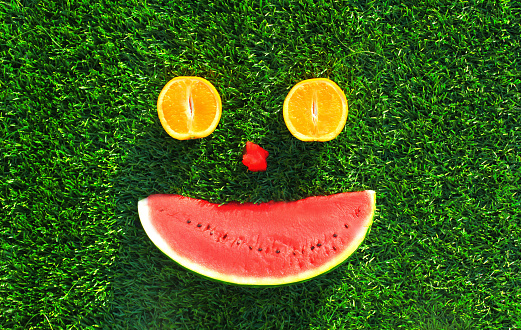 Summer fresh slice of watermelon on the grass background