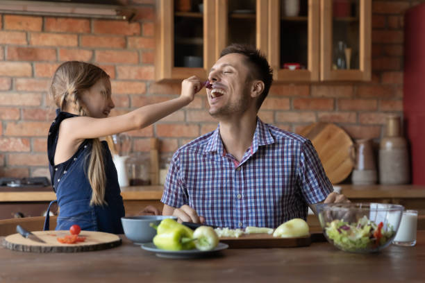 istock Happy kid and father engaged in cooking at home 1405601251