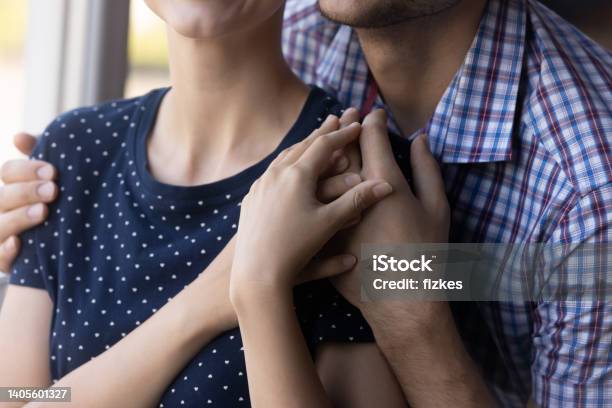 Close Up Shot Of Young Couple Hugging At Window Stock Photo - Download Image Now - Miscarriage, Support, Cancer - Illness