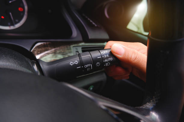 istock Driver hand turns the headlight switch lever on 1405601353