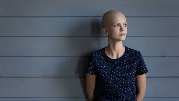 istock Serious thoughtful cancer fighter looking away with hope 1405601370