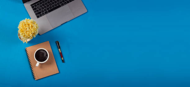 istock Minimalist office table with blue background and office supplies 1405603880