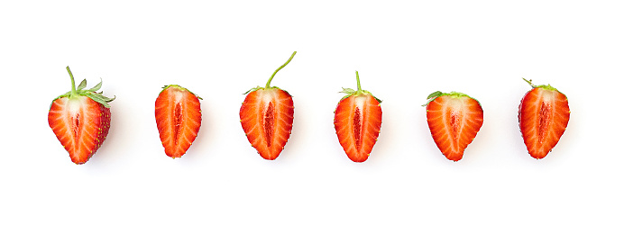 Long picture with row of slices natural strawberry isolated on white