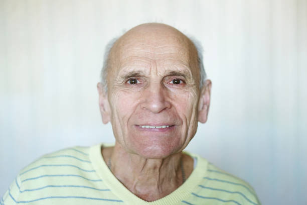 istock Close up portrait of elder man smiling with teeth 1405604325