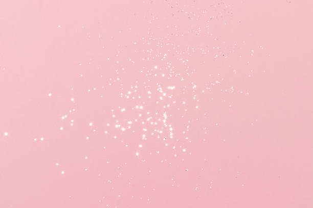 istock Sparkling silver glitter on pink background 1405606142