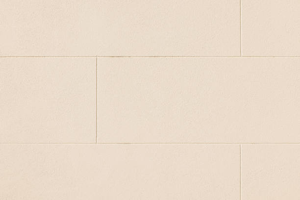 istock Part of a cream colored concrete block wall 1405607121