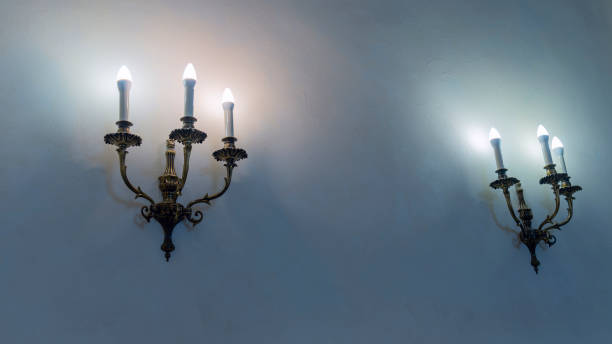 istock Vintage wall lamp. Space for text. Lamp light on the wall. Working lamps at dusk. 1405608150