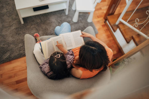 istock Daughter and japanese mom read a book 1405609163