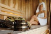 Selective focus of woman in sauna and accessories