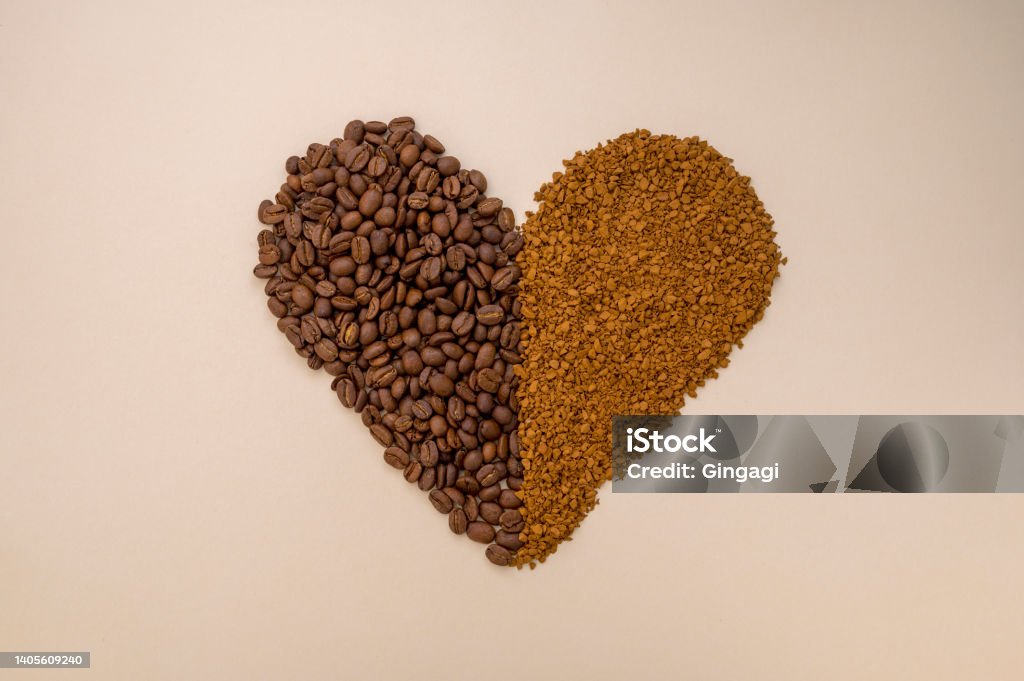 Abstract coffee concept. Ground, instant coffee and coffee beans in heart shape on warm, neutral background Abstract coffee concept. Ground, instant coffee and coffee beans in heart shape on warm, neutral background, top view Instant Coffee Stock Photo