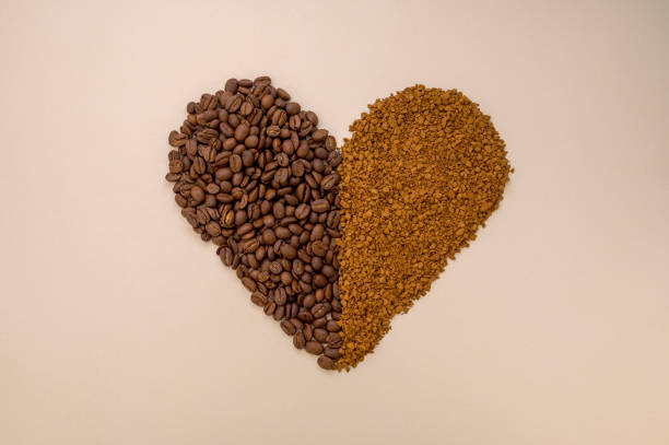 abstract coffee concept. ground, instant coffee and coffee beans in heart shape on warm, neutral background - coffee cup bean sugar imagens e fotografias de stock