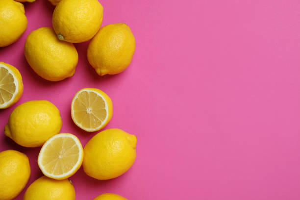 istock Ripe lemons on pink background, space for text 1405609295