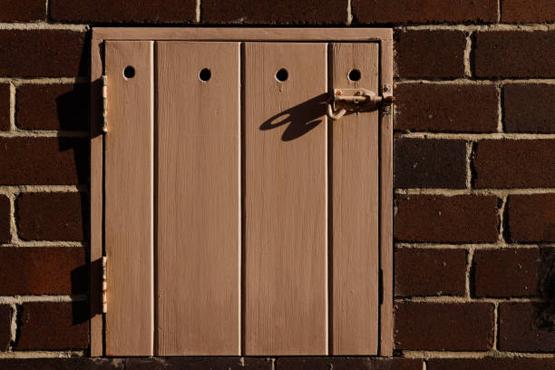 istock Old dark Brown brick wall with a wooden door 1405609297