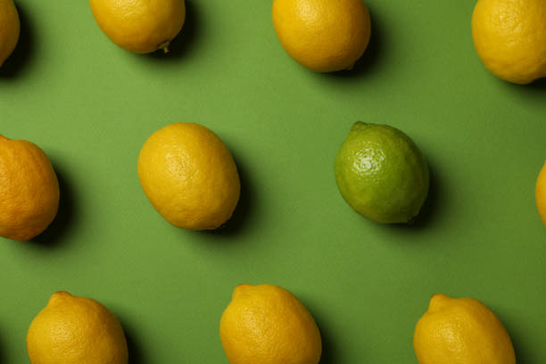 istock Ripe lemons and lime on green background, top view 1405609506