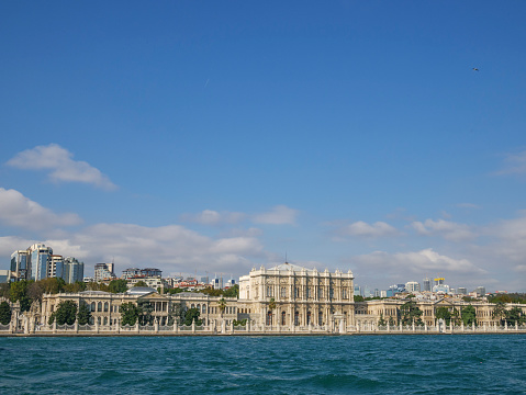 The Dolmabahce palace as seen from the Bosphorus in Istanbul. Turkey during a beautiful day at the end of summer.