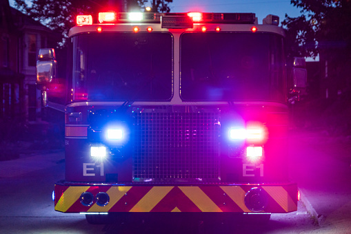 Plainsboro, NJ, USA - March 28, 2022: Back of the firetruck with firefighter and hoses equipment ready to use during accident