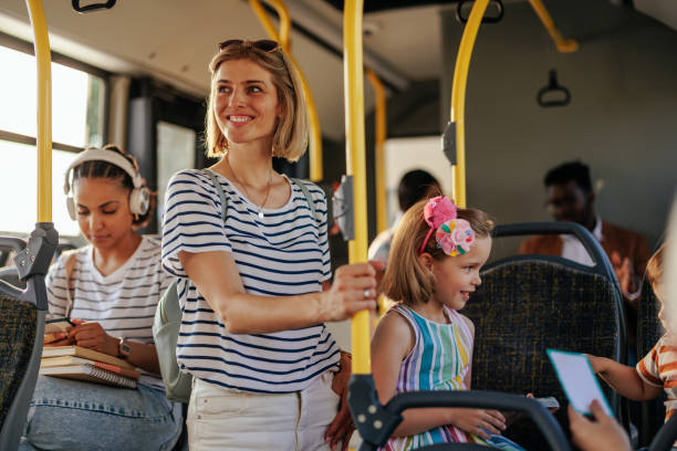 istock Young mom and daughter taking bus 1405612250