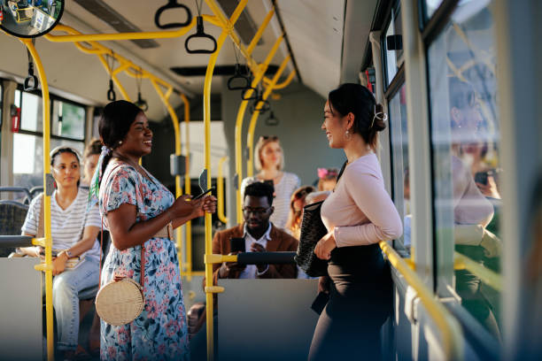 istock Young women talking in public transportation bus 1405612258