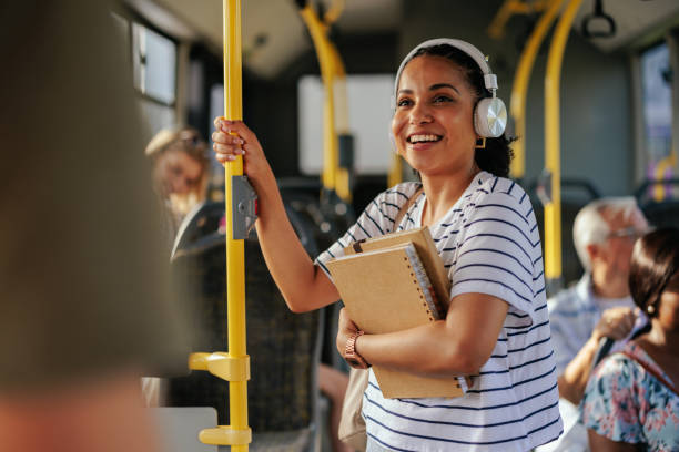 student on public transport listening to music - multi ethnic group family child standing imagens e fotografias de stock