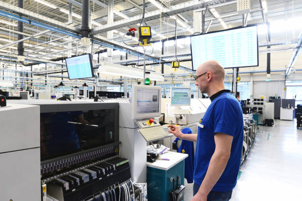 production and assembly of microelectronics in a hi-tech factory - man operates machine in production