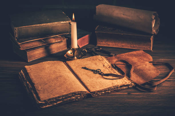 istock Blank antique leather-bound journal, book or diary with old books and candle 1405612601