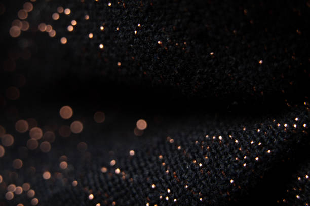 istock black fabric with shiny splashes in blurred focus, macro photo 1405613416