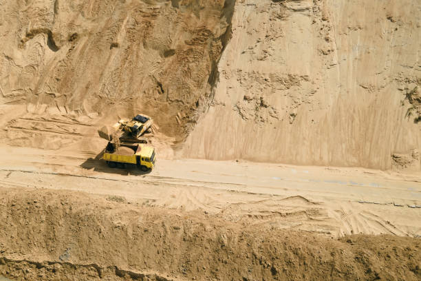 istock Excavator loading sand into truck in opencast sand quarry 1405613785