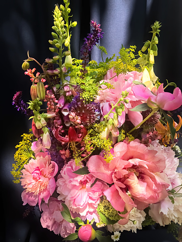 Romantic bouquets of flowers. Home decor and flowers arranging. In composition used peonies, sage, foxglove, geyhera, parsnip