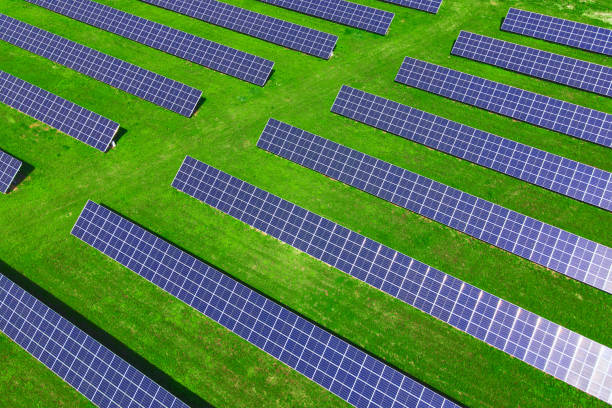 istock Solar panels in green field, aerial view 1405614319