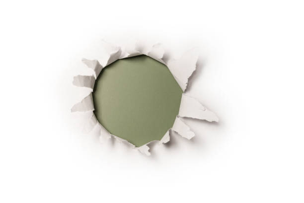 istock A hole in a white paper on a red background, copy space. 1405616090