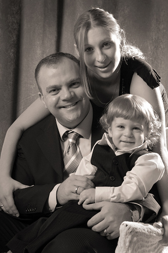 Black-and-white photo of the  family: dad, mom and child