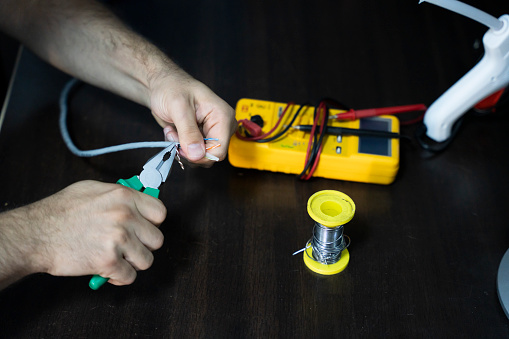 pliers, screwdriver and energy meter prepared for repairing computer parts