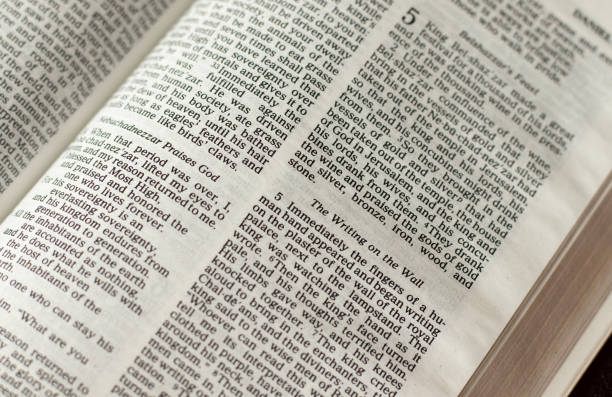 istock Writing on the wall verses in an open Holy Bible Book 1405619966