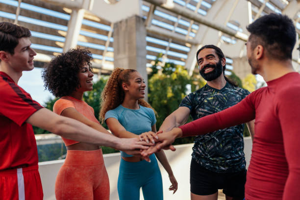 istock Sporty young people joining their hands together in a huddle 1405619990