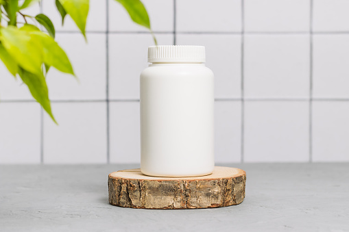 Medical vitamin mockup bottle of bio supplement on wooden stand