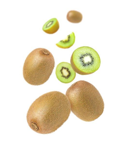 istock Kiwi fruit with cut half slice flying in the air isolated on white 1405623509