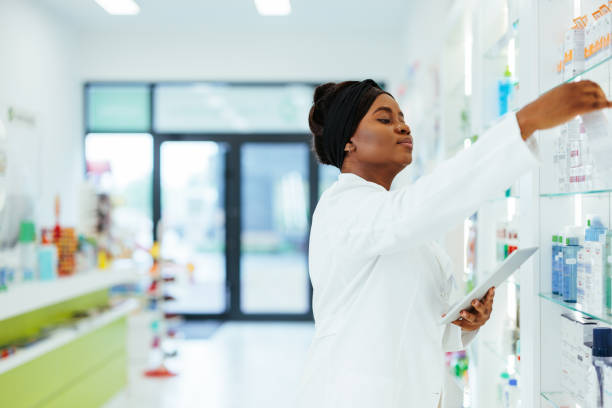 istock Pharmacist restocking pharmacy shelves 1405624072
