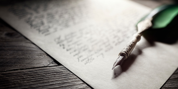 Writing letter to a friend. Selective focus and shallow depth of field.