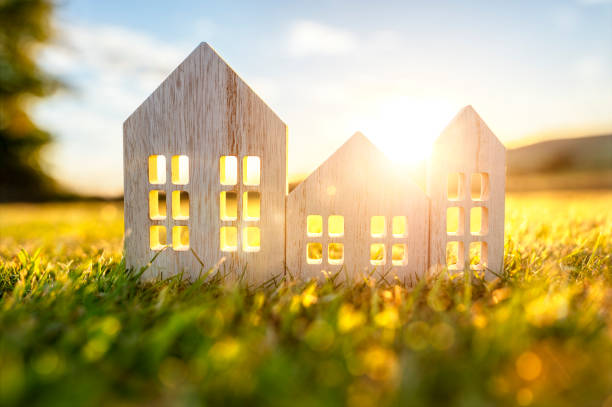 green ecological wood house in empty field at sunset concept for construction and real estate - banking district imagens e fotografias de stock