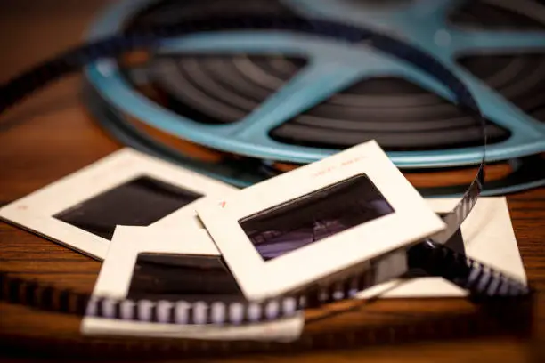Photo of Shallow focus background image of 35mm slides and 8mm Super 8 film reel with vintage filter