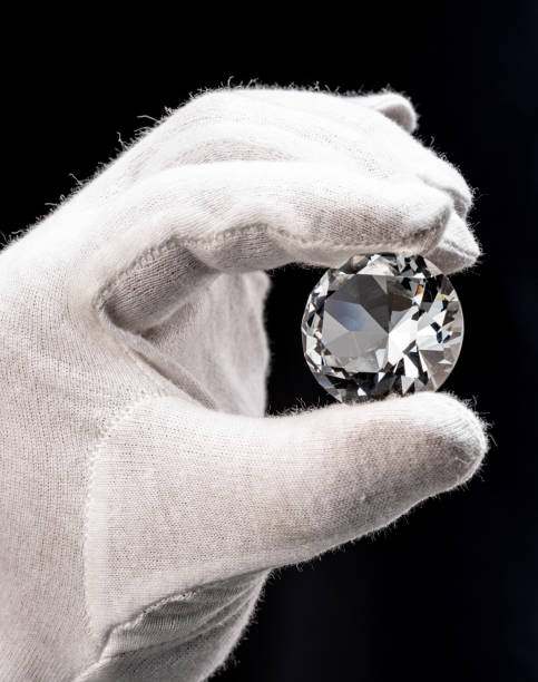 istock Large gemstone in jeweler's hand close up. Gem identifying and evaluating process. 1405627477