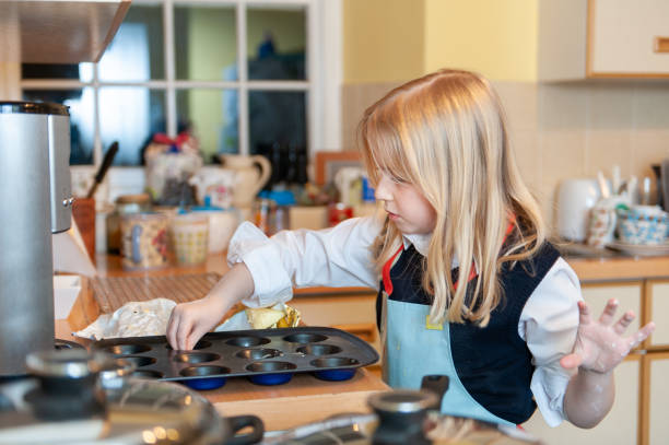 istock Pretty young blonde girl baking in a messy kitchen 1405629269