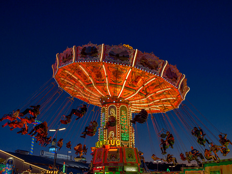 Rotating chain carousel at the blue hour on the Oktoberfest, Munich, Bavaria, Germany, Europe, 03. October 2019