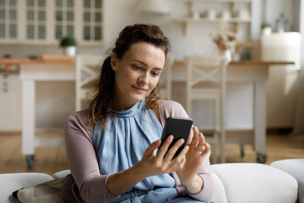istock Positive focused woman using virtual ecommerce app om mobile phone 1405631051